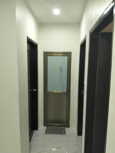 a hallway with two doors and a tile floor at Home stay in Pasig in Pasig