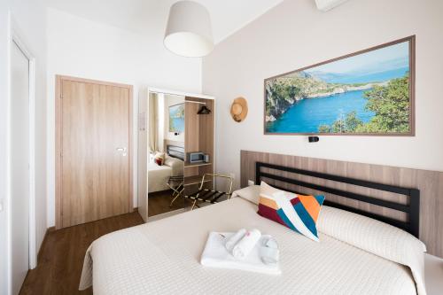 a bedroom with a bed with a tv on the wall at Panoramic Rooms Salerno in Salerno