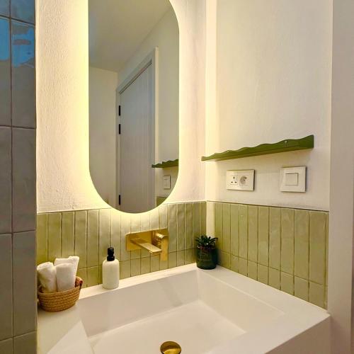 a bathroom with a large white tub with a mirror at Ti Paradis with Private rooftop in Grand-Baie