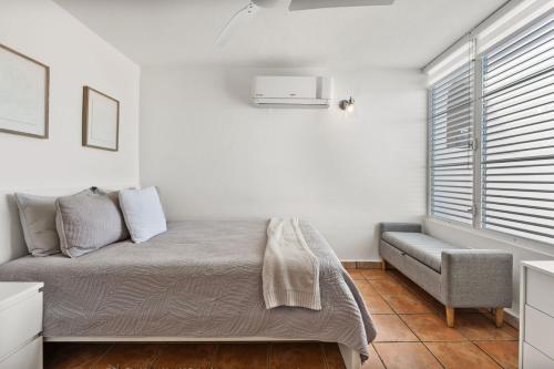 a bedroom with a bed and a chair and a window at Beachfront apt with amazing views in Stella