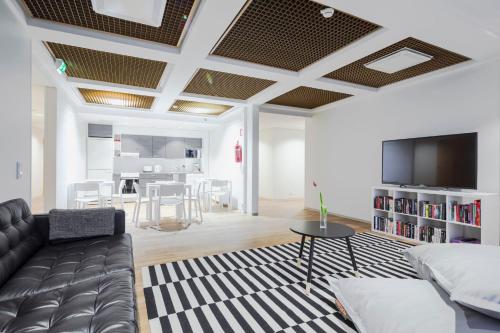 a living room with a couch and a tv at Hostel Café Koti in Rovaniemi