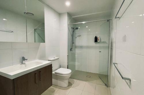 a bathroom with a shower and a toilet and a sink at Big, Bold, Barton in Barton