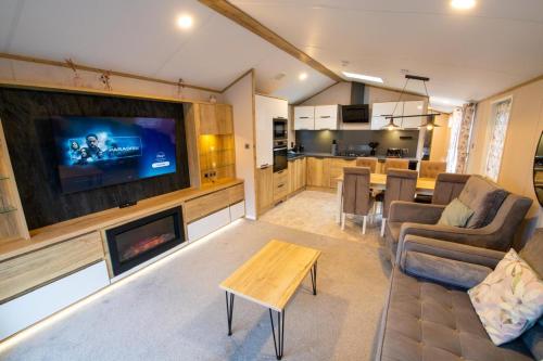 a living room with a tv and a fireplace at Valley 127A - Coghurst Hall in Westfield