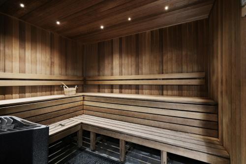 an empty sauna with wooden walls and benches at The Piastri at Midnight in Braddon