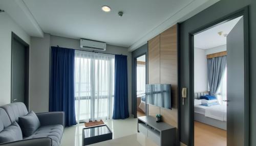 a living room with a couch and a bedroom at 3 Bed Room One Residence by momo in Pulau Sembakau Kecil