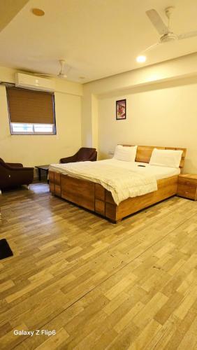 a bedroom with a large bed in a room at Hotel ShivInn in Gandhinagar