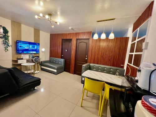 a living room with a couch and a table and chairs at Mamby Gray's Place Balcony, Karaoke ,Wifi,Netflix &Kitchen in Imus
