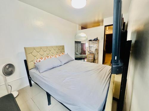 a small bedroom with a bed in a room at Mamby Gray's Place Balcony, Karaoke ,Wifi,Netflix &Kitchen in Imus