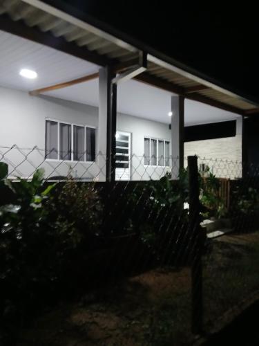 a house with a fence in front of it at Kitnet na mata atlantica in Ubatuba