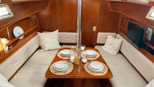 a table in the center of a boat with plates and candles at Velero Nadya in Arrecife