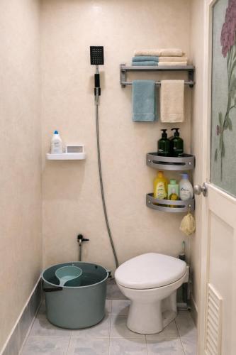a bathroom with a bath tub next to a toilet at The Stoked Hideout - Bagasbas Beach in Daet