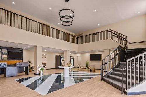 a lobby with a staircase and a living room at B&B HOTEL Jacksonville Airport - Newly Renovated! in Jacksonville