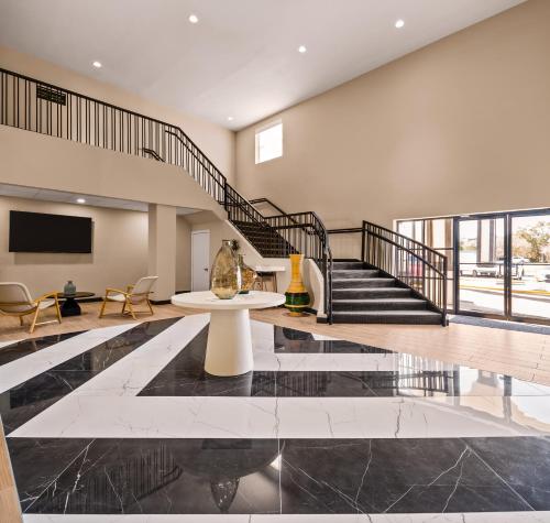 a living room with a table and a staircase at B&B HOTEL Jacksonville Airport - Newly Renovated! in Jacksonville