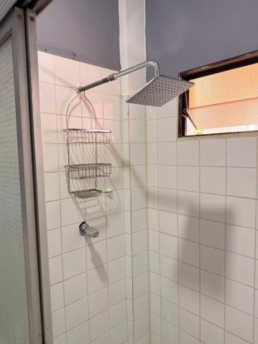 a shower with two baskets on the wall at La Casona Guest House in La Unión