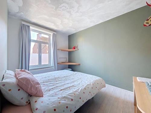 a bedroom with a bed and a window at Bed and Bert in Leuven