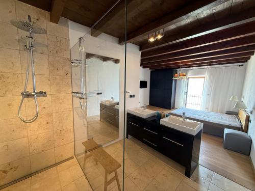 a bathroom with a shower and a sink and a tub at Casa borgo Arias Lake View in Tremosine Sul Garda
