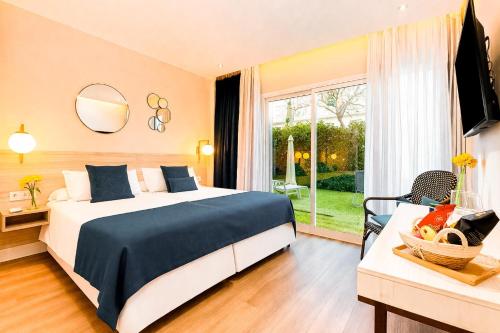 a hotel room with a bed and a window at Nura Houses Condor in Playa de Palma