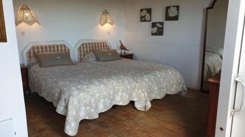 a bedroom with a bed with two pillows on it at Quinta Martins in Loulé