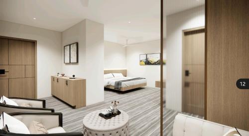 a bedroom with a bed and a table and chairs at Rest and Rise Inn in Bhīmavaram