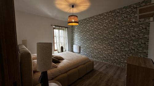 a living room with a couch and a window at Escapade au cœur du Haras in Le Mesnil-Rouxelin