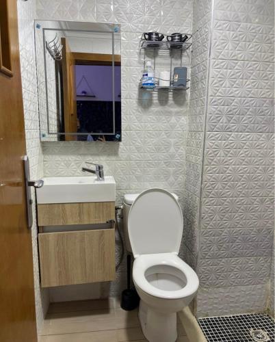 a bathroom with a toilet and a sink and a mirror at saviohome in Ouarzazate