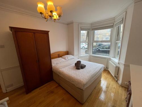 a bedroom with a bed with a teddy bear on it at The Crandale Road House in Bath