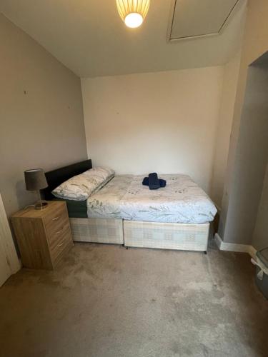 a bedroom with two beds and a hat on the bed at The Crandale Road House in Bath