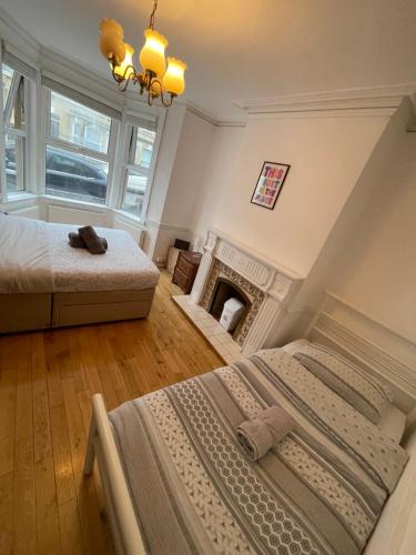 a bedroom with two beds and a fireplace at The Crandale Road House in Bath