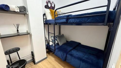 a room with two bunk beds and a chair at Estudio con piscina in Roses