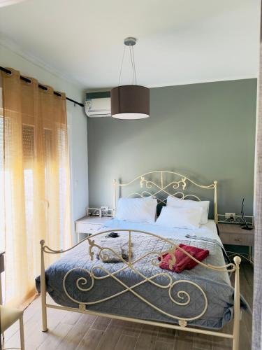 a bedroom with a bed with a metal frame at Casa Nikolou Stegna in Archangelos