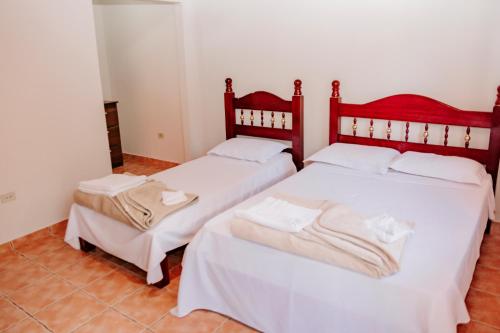 two beds sitting next to each other in a room at Pousada Vilarejo de Minas in Itapeva