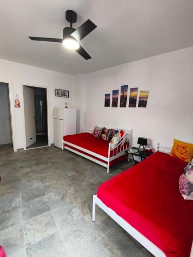 a living room with two beds and a refrigerator at Blue Port Faros - Sifnos in Faros