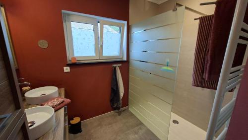 a bathroom with a toilet and a sink and a window at "En Aqualye" Appartement 2 personnes chez l'habitant in Aywaille
