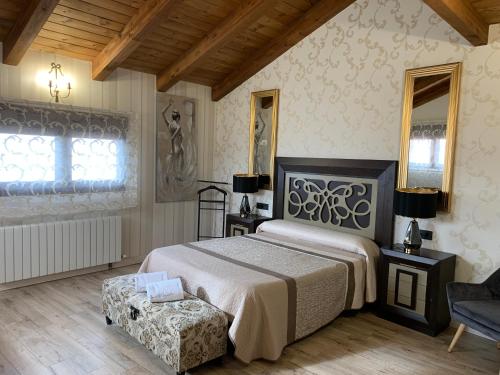 a bedroom with a bed and a chair and a window at Casa Regidor2 in Rábano