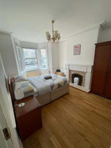 a large bedroom with a bed and a fireplace at The Crandale Road House in Bath