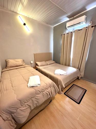 a bedroom with two beds and a window at CDE House in Ciudad del Este