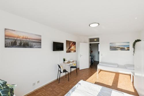 a living room with a bed and a table at Apartment mit Balkon in Lünen in Lünen