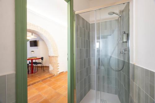 a glass shower in a bathroom with a table at Luce sul Duomo in Tivoli