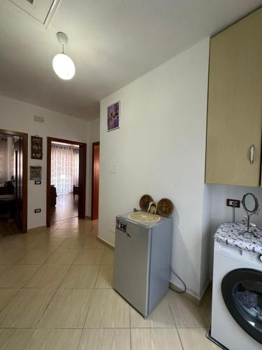 a kitchen with a refrigerator and a washer and dryer at Vila Du Lac Blue in Lin