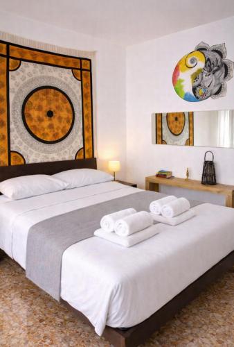 two beds in a hotel room with towels on them at L'isola felice in Cecina