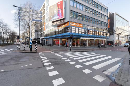 an empty street with a crosswalk in front of a building at easyHotel Rotterdam City Centre in Rotterdam