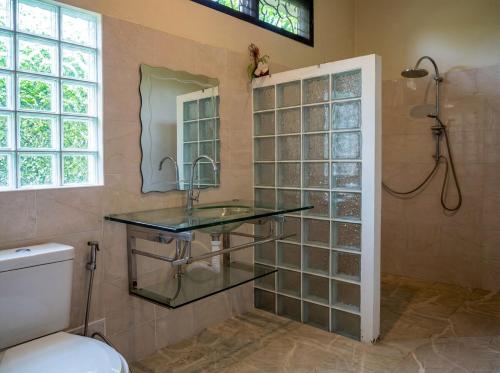 a bathroom with a glass sink and a shower at Ayeda Villa 2 in Krabi