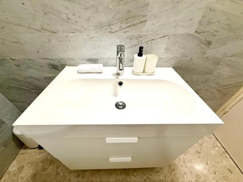 a white bathroom sink with a bottle of soap at Latchi Premium View in Lachi