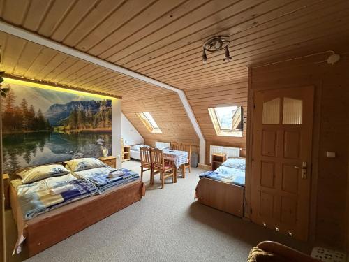 a bedroom with two beds and a table in it at ANTON Tenczyn in Tenczyn