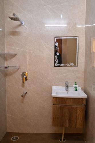 a bathroom with a sink and a shower at The Happy Nook Stays in Winsten Park Knowledge Park V in Noida
