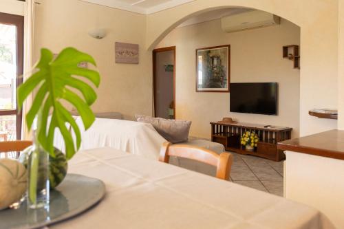 a living room with a couch and a tv at Appartamenti Bellavista by ElbaSummer in Portoferraio