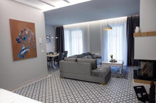 a living room with a couch and a table at Id-Real Villa in Golem