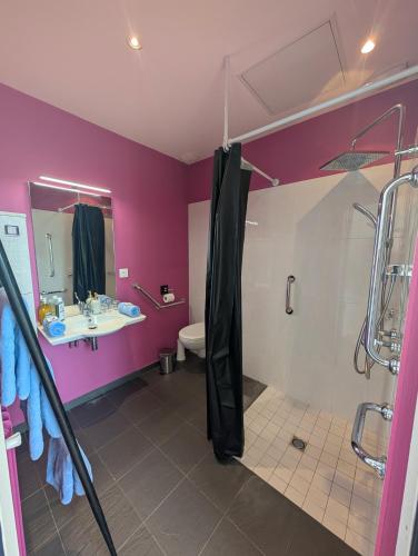 a bathroom with a shower and a sink and a toilet at Château de Briançon, The Originals Relais in Bauné