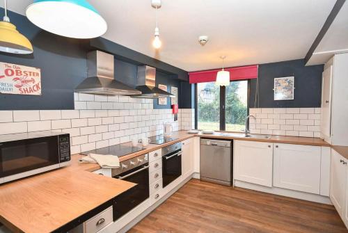 a kitchen with white appliances and a wooden counter top at 2 Private Rooms in Shared Apartment with Kitchen in Leeds