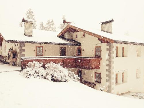 a house covered in snow at Chalet Alpina in Ortisei